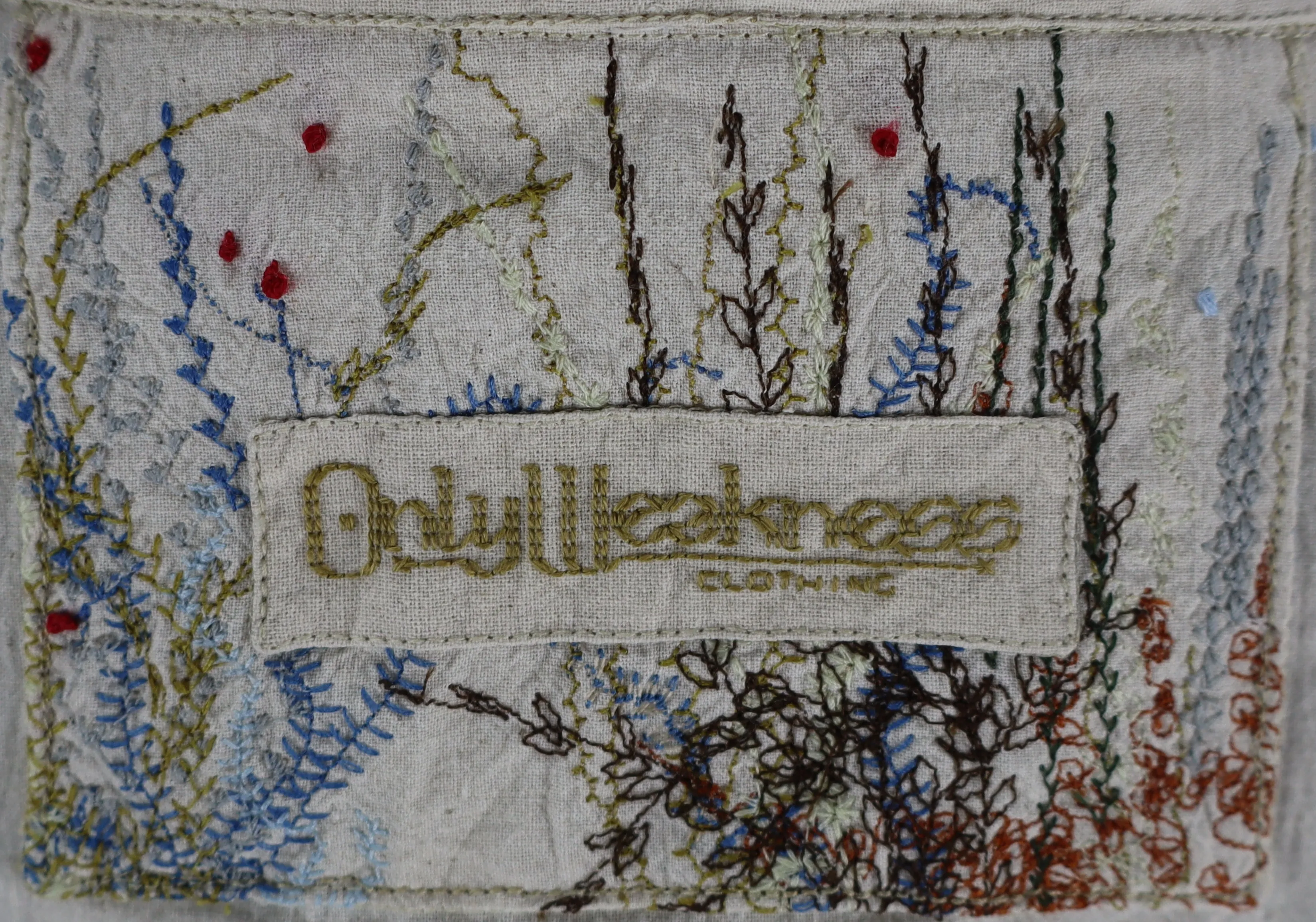 our hand-stitched tag, reading 'only weakness'