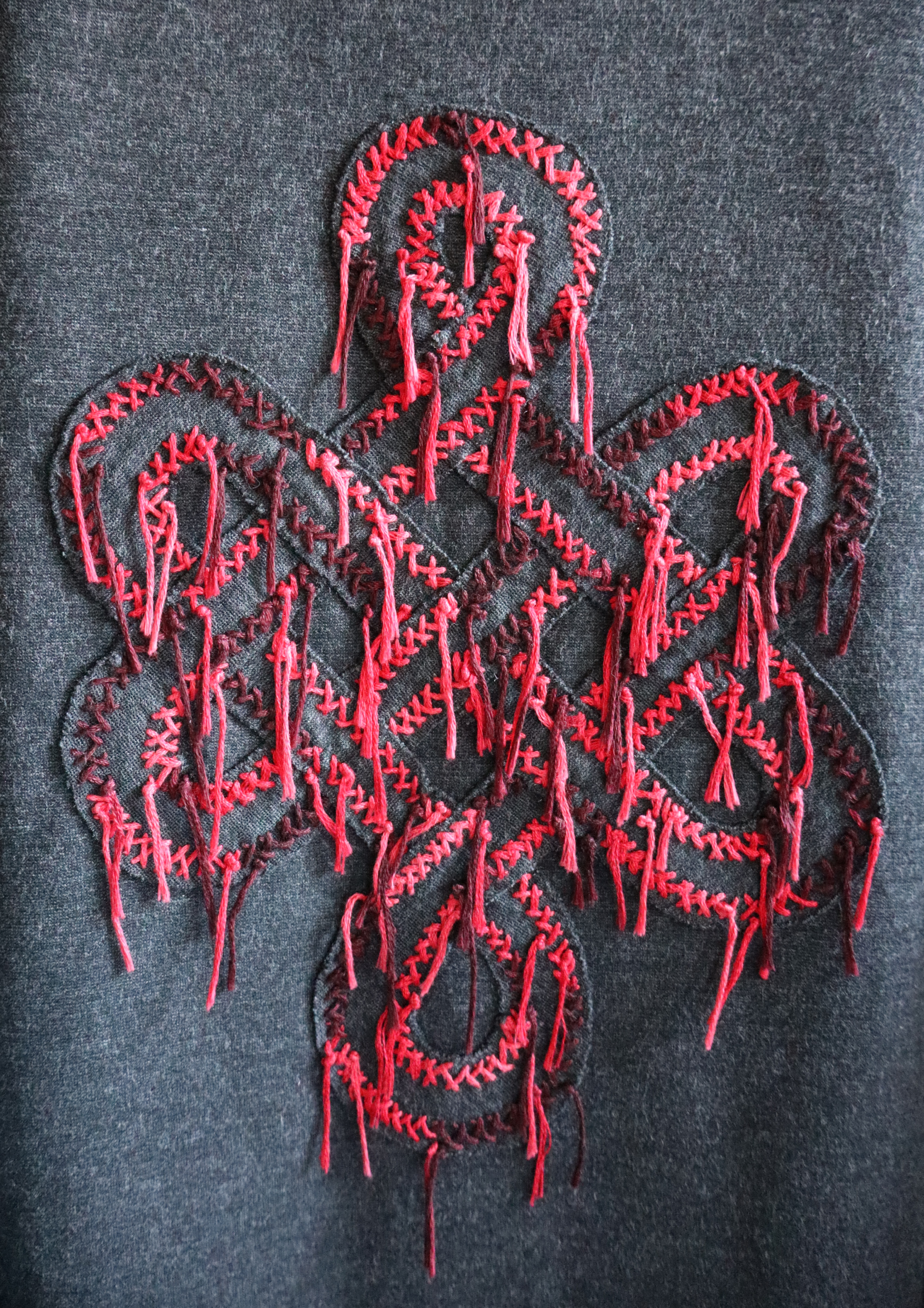 Close view of the emblem on the Uncursed T-Shirt